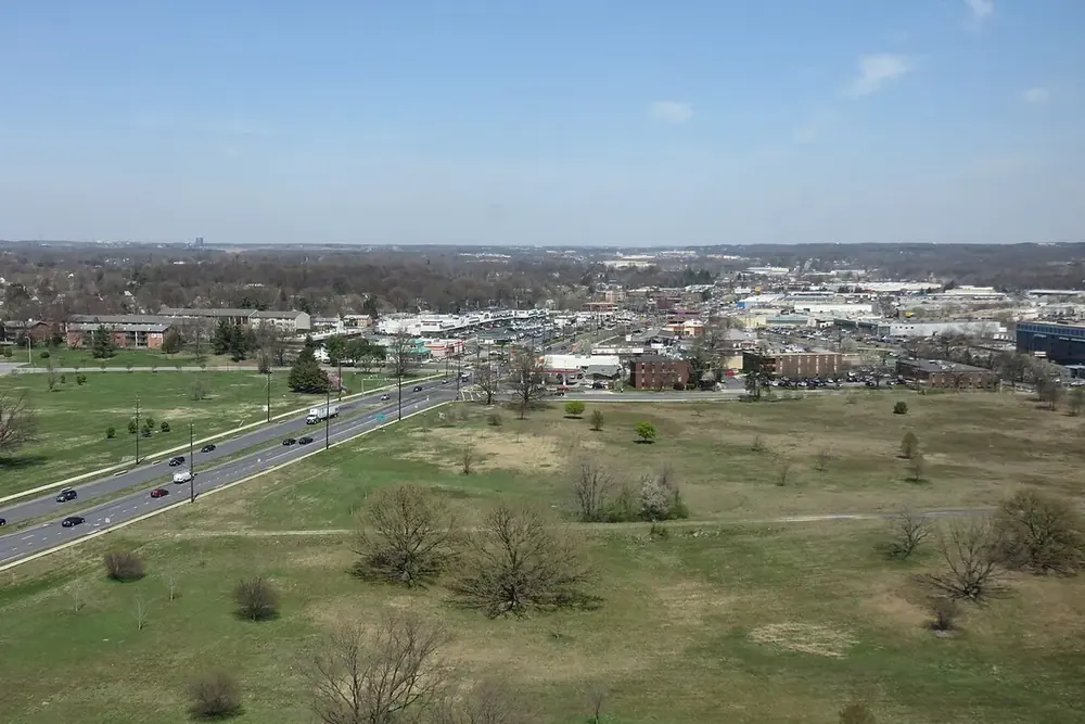 Elevated view over open fields, a highway and low buildings of Beltsville, Maryland