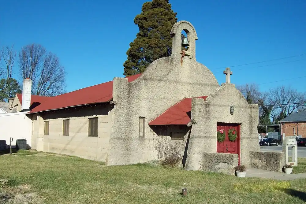 Stucco Chapel of the Incarnation with a bell gable and red roof in Brandywine, Maryland