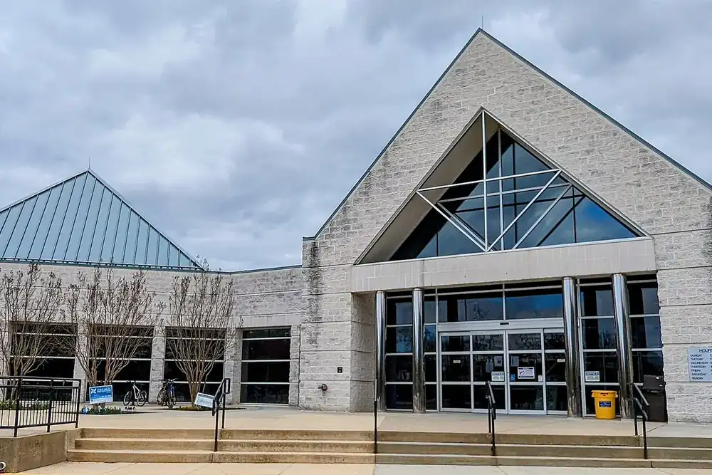 Centreville Regional Library with a pointed glass entrance under a cloudy sky in Centreville, Virginia