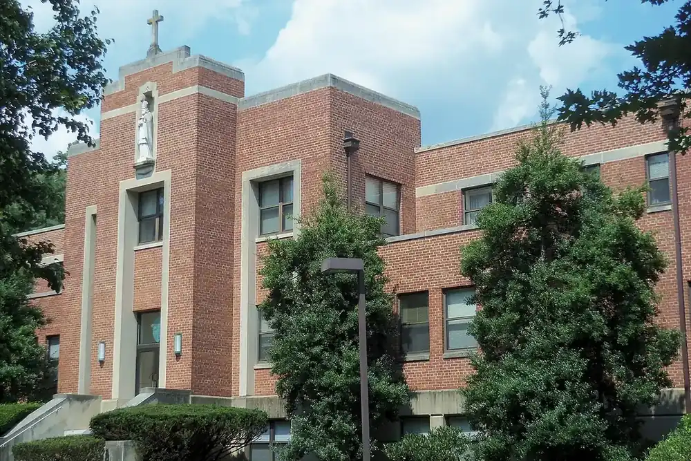 Brick Archdiocese of Washington Pastoral Center with a cross atop its tower in Chillum, Maryland