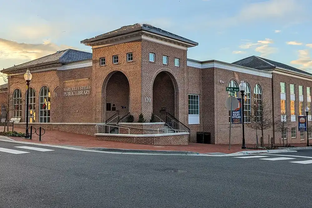 Brick Mary Riley Styles Public Library with arched entrances on a street corner in Falls Church, Virginia