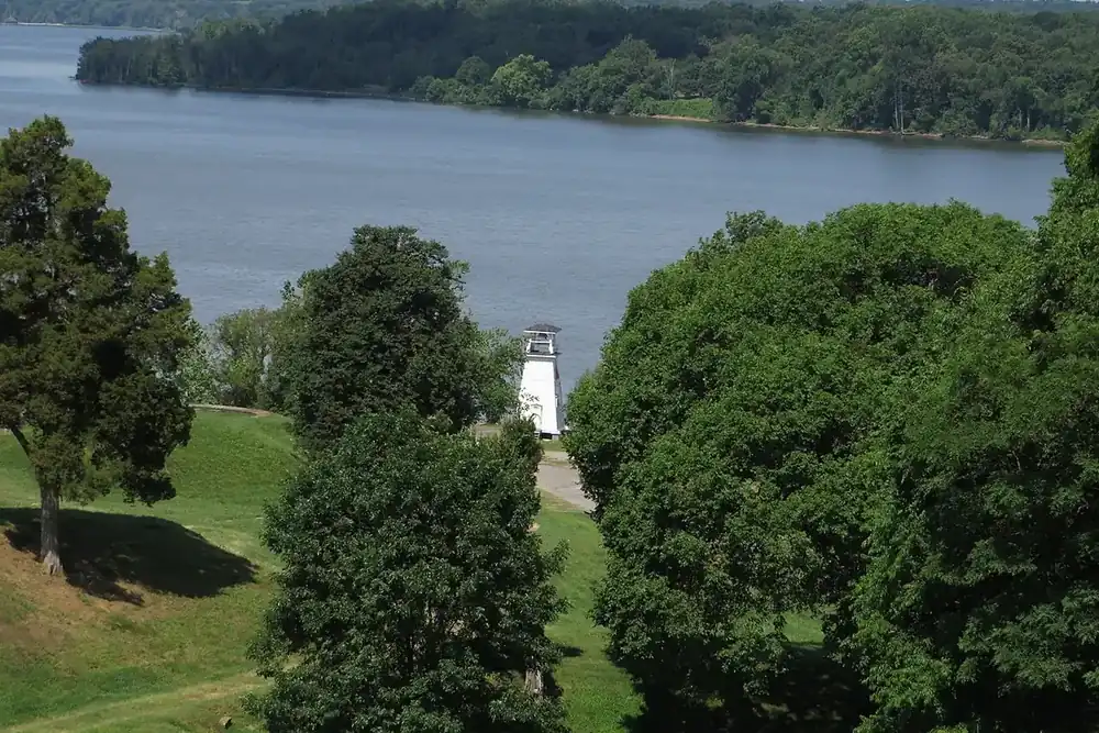 Fort Washington Light and the Potomac River seen through trees in Fort Washington Park, Maryland
