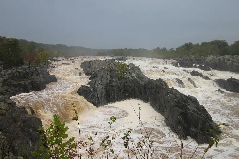 Rushing brown water over dark rocks at Great Falls Park in Virginia