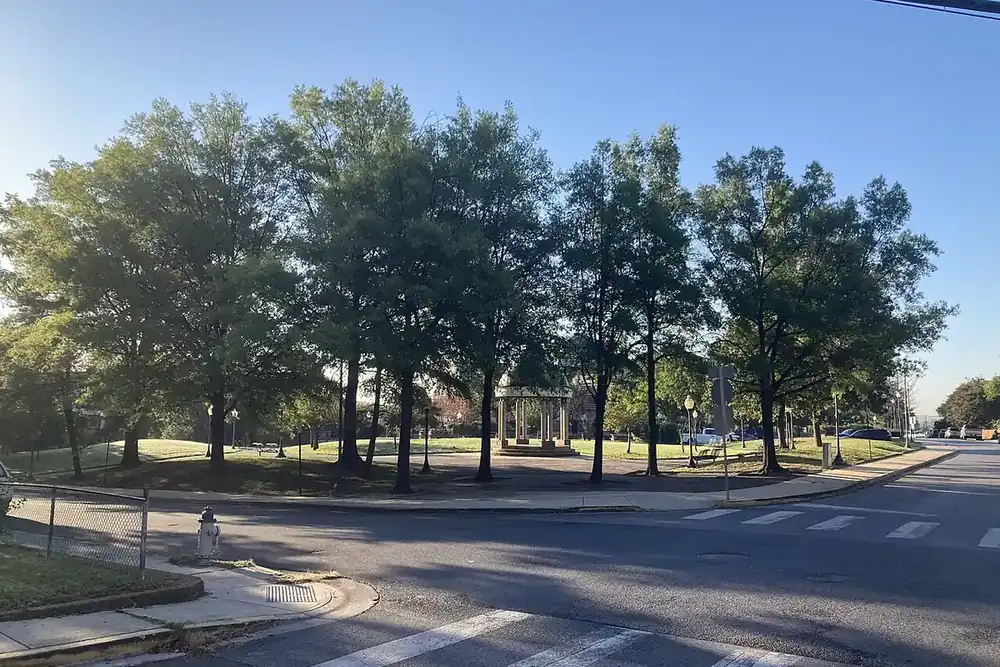 Shade trees and a white gazebo in a small corner park in Hyattsville, Maryland