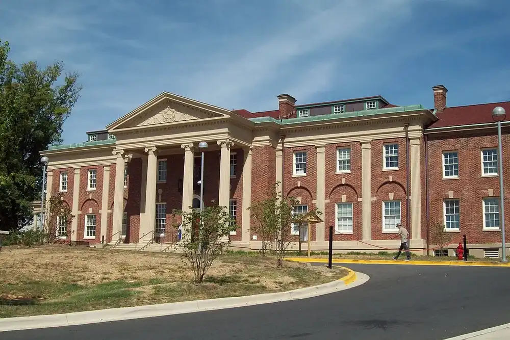 Columned brick McCormick-Goodhart Mansion beside a curving drive in Langley Park, Maryland